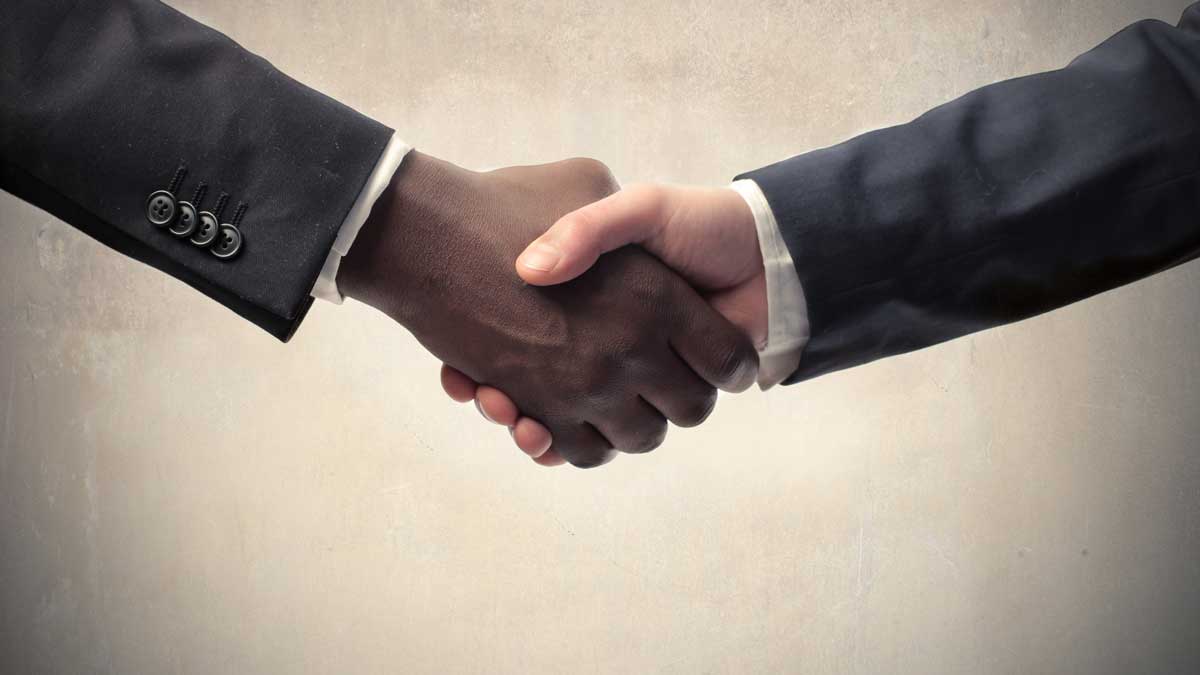 Black man and white man shaking hands