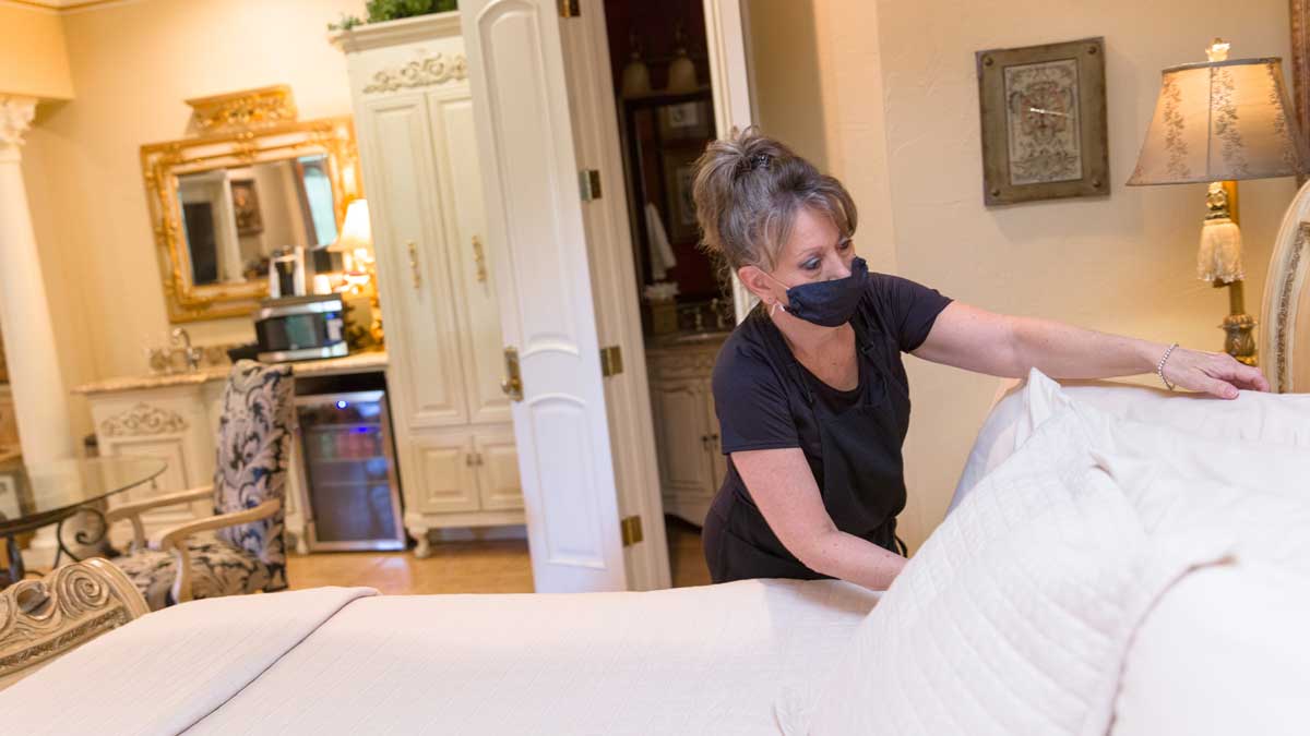 Deanna making a bed at Two Hearts Inn (Photo: <a href="https://edmondbusiness.com/author/brent-fuchs/">Brent Fuchs</a>)
